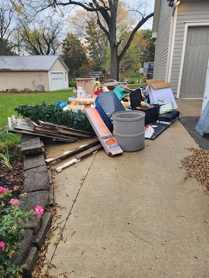 Dumpster being loaded with debris for Commercial Dumpster Rental in Grosse Pointe Park